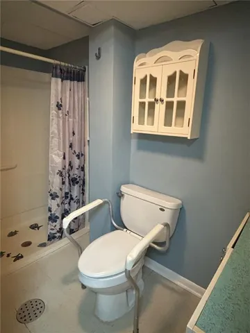 a white toilet sitting next to a bathroom sink