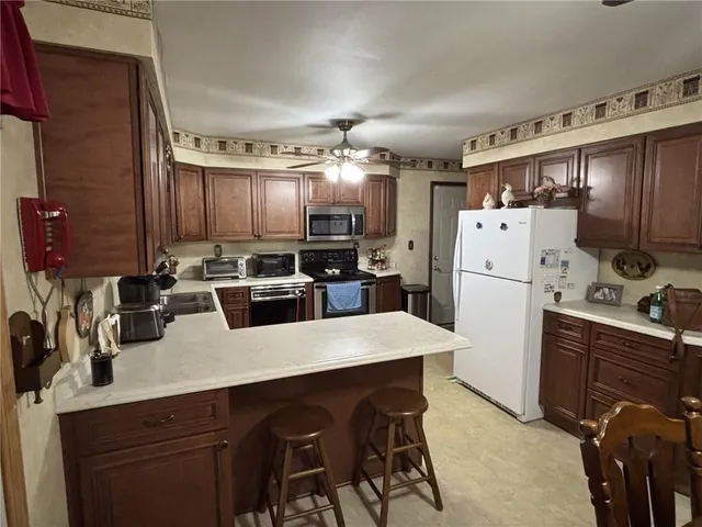 a kitchen with refrigerator and cabinets