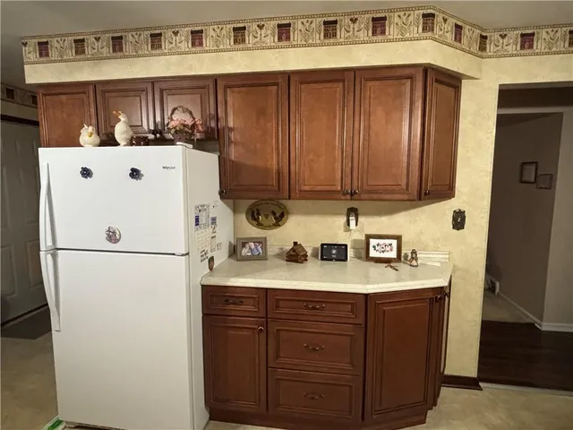 a white refrigerator freezer sitting inside of a kitchen