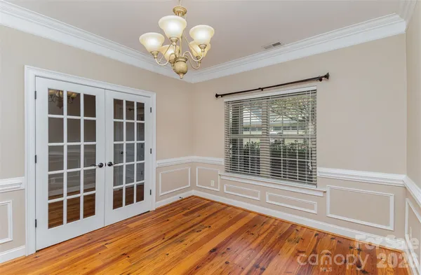 a view of wooden floor and windows in a room