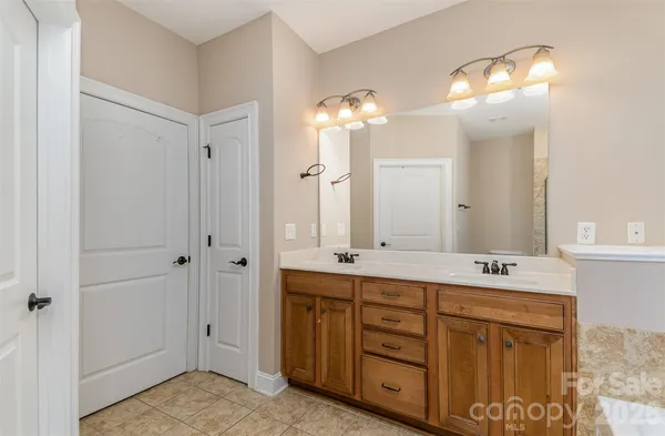 a bathroom with a double vanity sink and a mirror