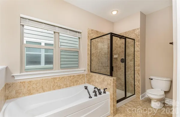a bathroom with a bathtub and a toilet