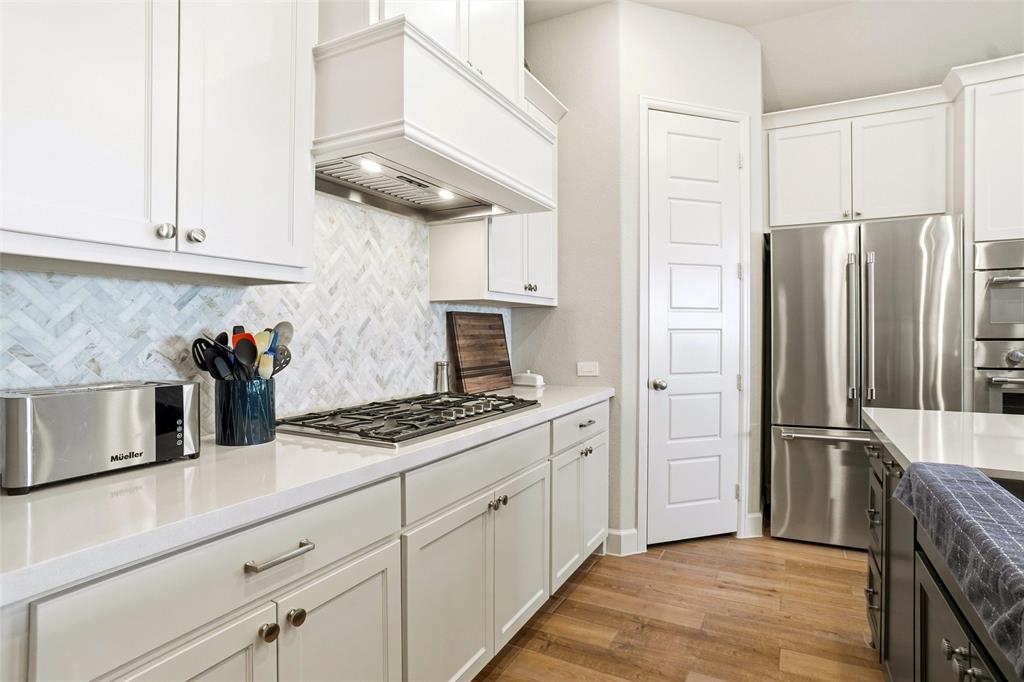 118 Alamito Road Rhome, TX 76078 - Photo 12 of 37 a kitchen with stainless steel appliances granite countertop a refrigerator and a stove top oven