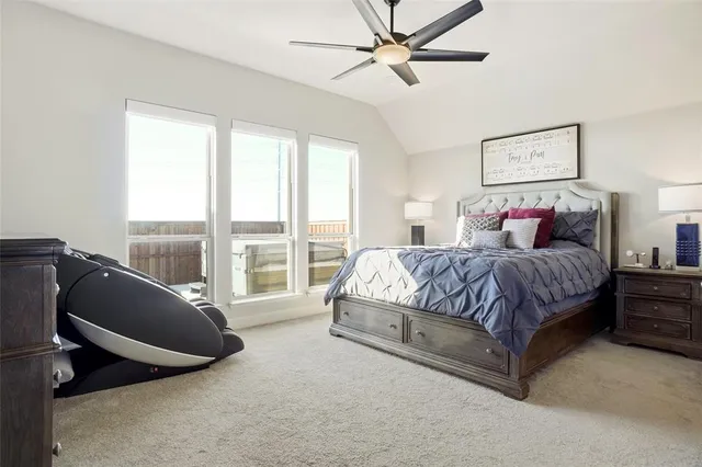 a spacious bedroom with a large bed and a chandelier