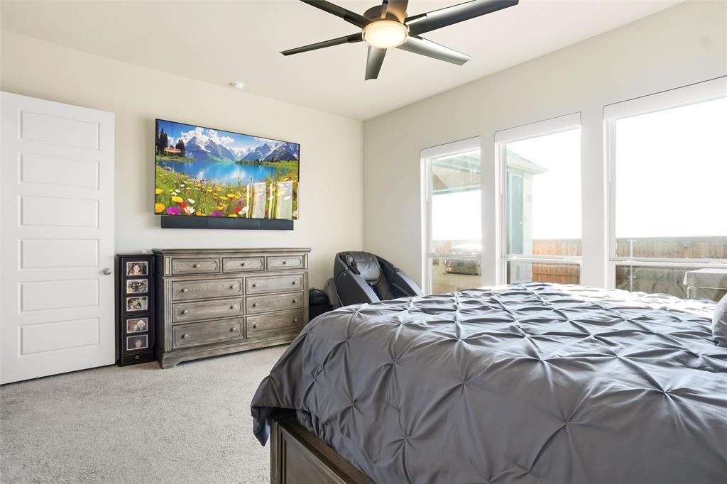 118 Alamito Road Rhome, TX 76078 - Photo 17 of 37 a bed sitting in a bedroom next to a window