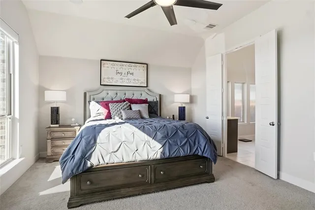 a bedroom with a bed and painting on the wall