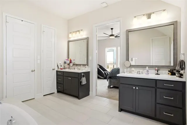 a bathroom with a double vanity sink and mirror