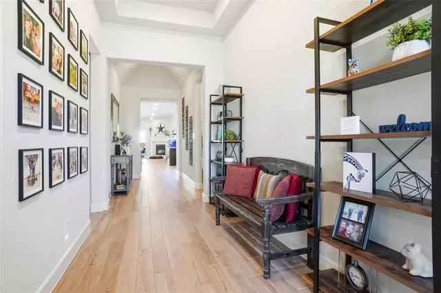 a living room with furniture and a book shelf