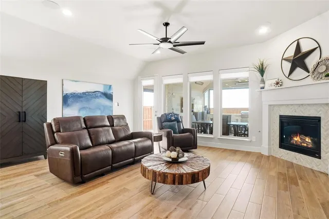 a living room with furniture a fireplace and window