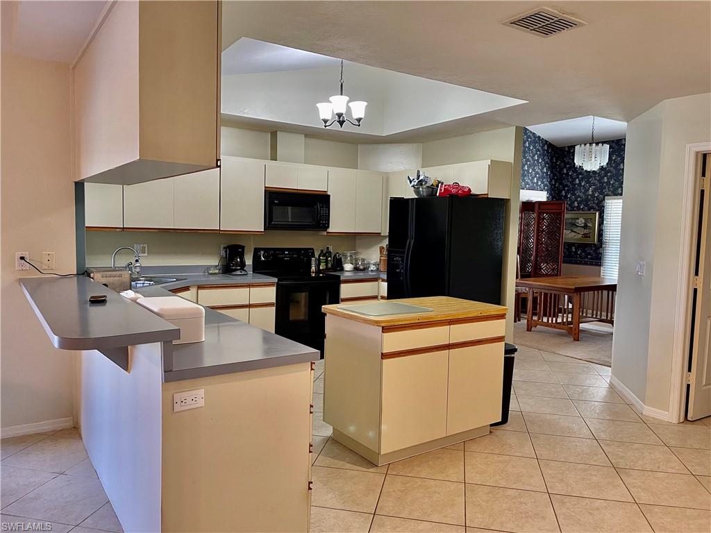 250 Pinehurst Circle Naples, FL 34113 - Photo 13 of 23 a kitchen with a sink a refrigerator and washer
