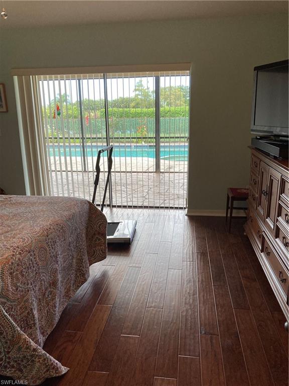 250 Pinehurst Circle Naples, FL 34113 - Photo 14 of 23 a spacious bedroom with a bed and a large window