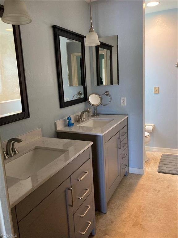 250 Pinehurst Circle Naples, FL 34113 - Photo 15 of 23 a bathroom with a sink and a mirror