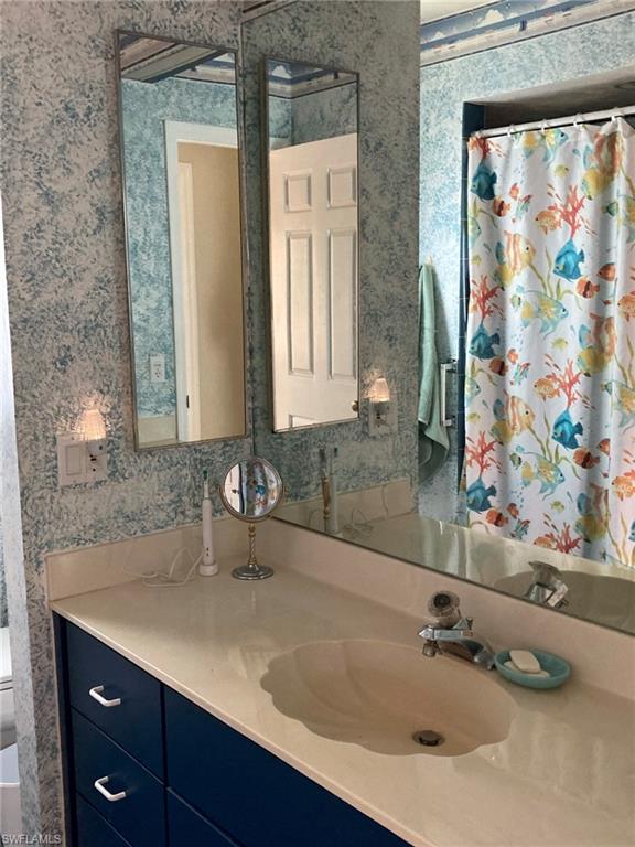 250 Pinehurst Circle Naples, FL 34113 - Photo 19 of 23 a bathroom with a sink and a mirror