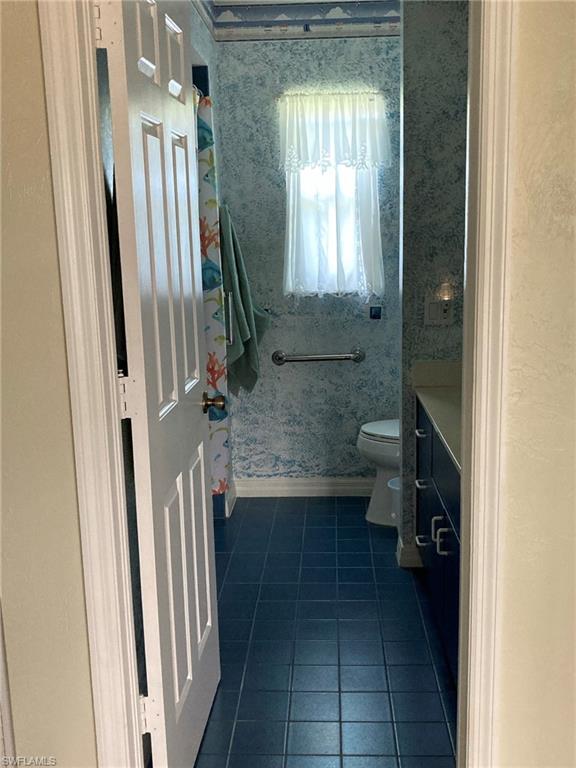 250 Pinehurst Circle Naples, FL 34113 - Photo 20 of 23 a bathroom with a sink a toilet and a mirror