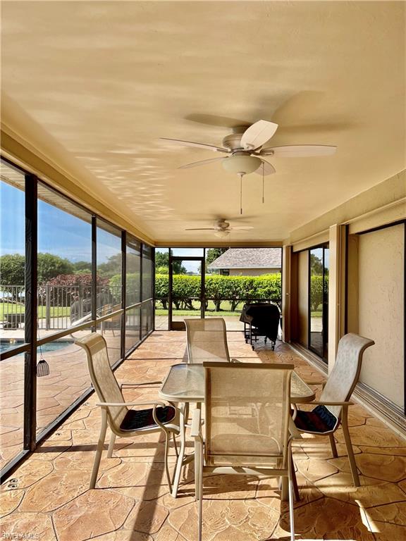 250 Pinehurst Circle Naples, FL 34113 - Photo 7 of 23 a view of a patio with a table chairs and a floor to ceiling window