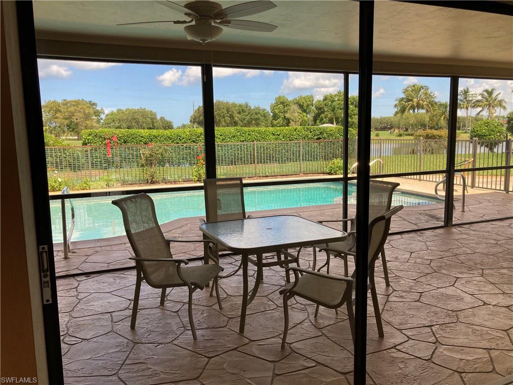 250 Pinehurst Circle Naples, FL 34113 - Photo 8 of 23 a view of a city from a dining room with large windows
