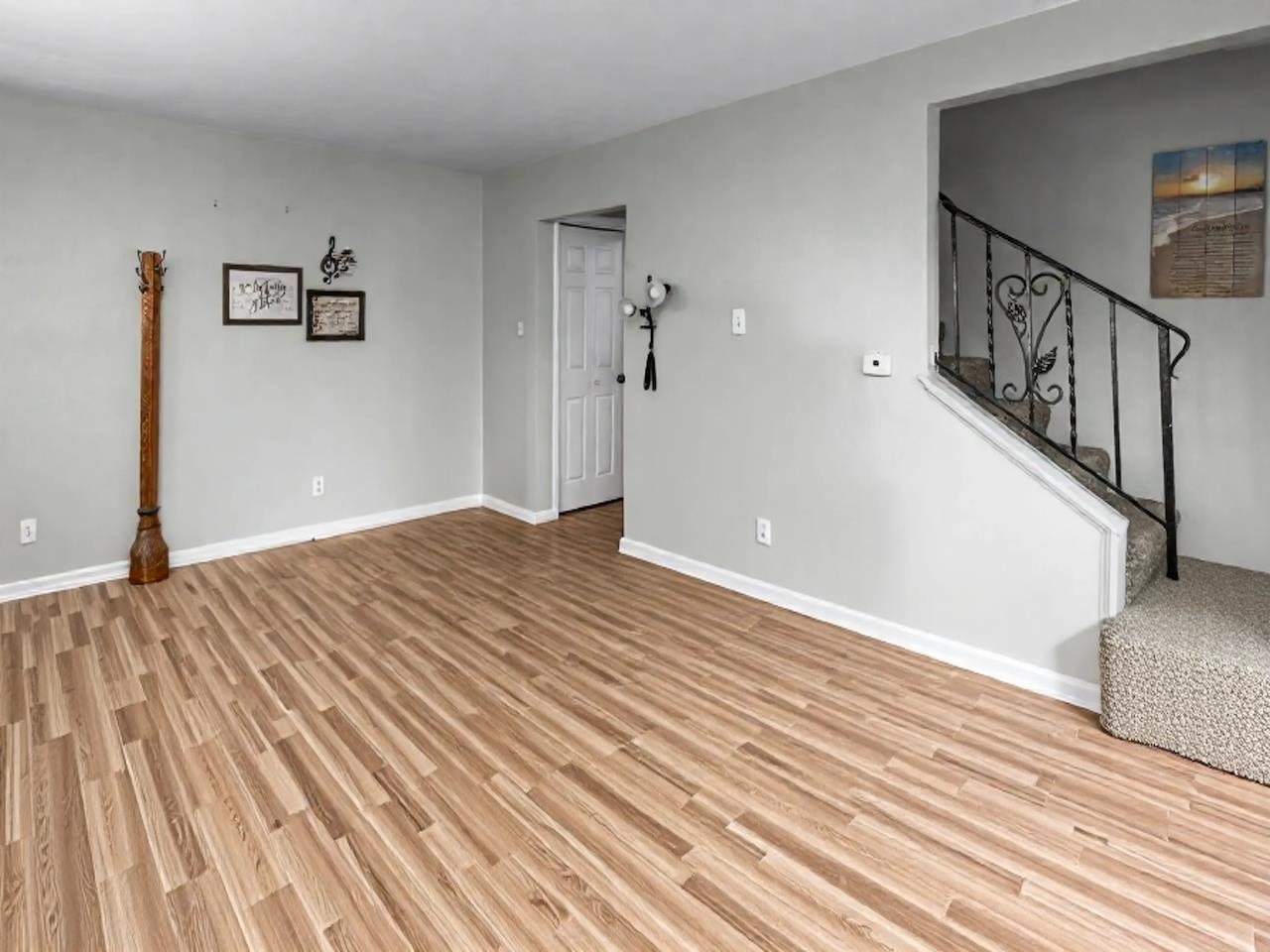 4315 26th Avenue Moline, IL 61265 - Photo 4 of 16 a view of a livingroom with wooden floor and stairs
