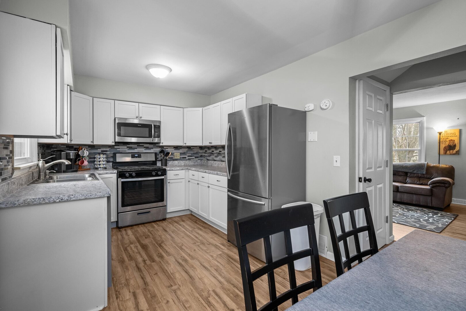 4315 26th Avenue Moline, IL 61265 - Photo 5 of 16 a kitchen with stainless steel appliances granite countertop a refrigerator stove microwave and sink