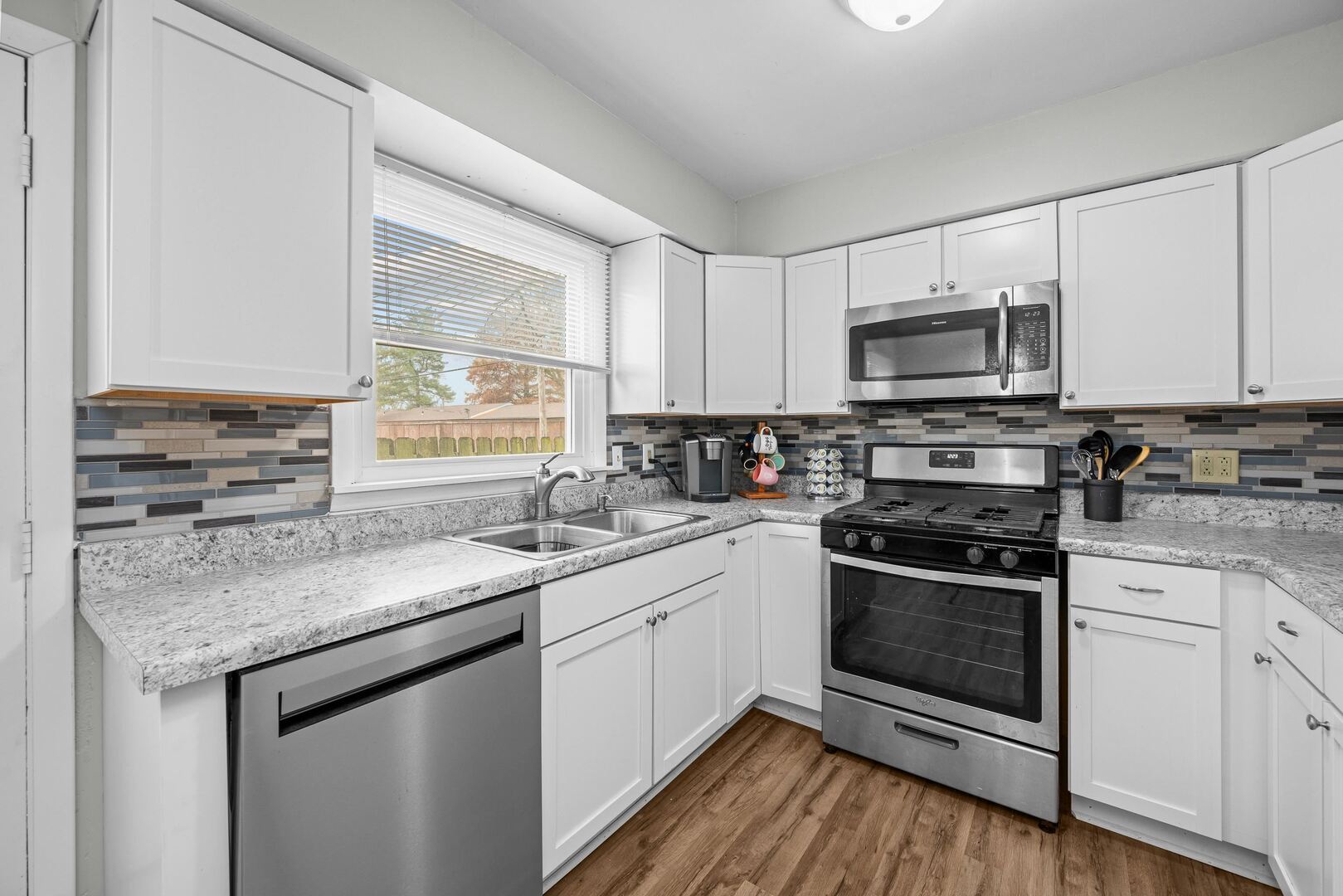 4315 26th Avenue Moline, IL 61265 - Photo 7 of 16 a kitchen with stainless steel appliances granite countertop a sink stove microwave and cabinets