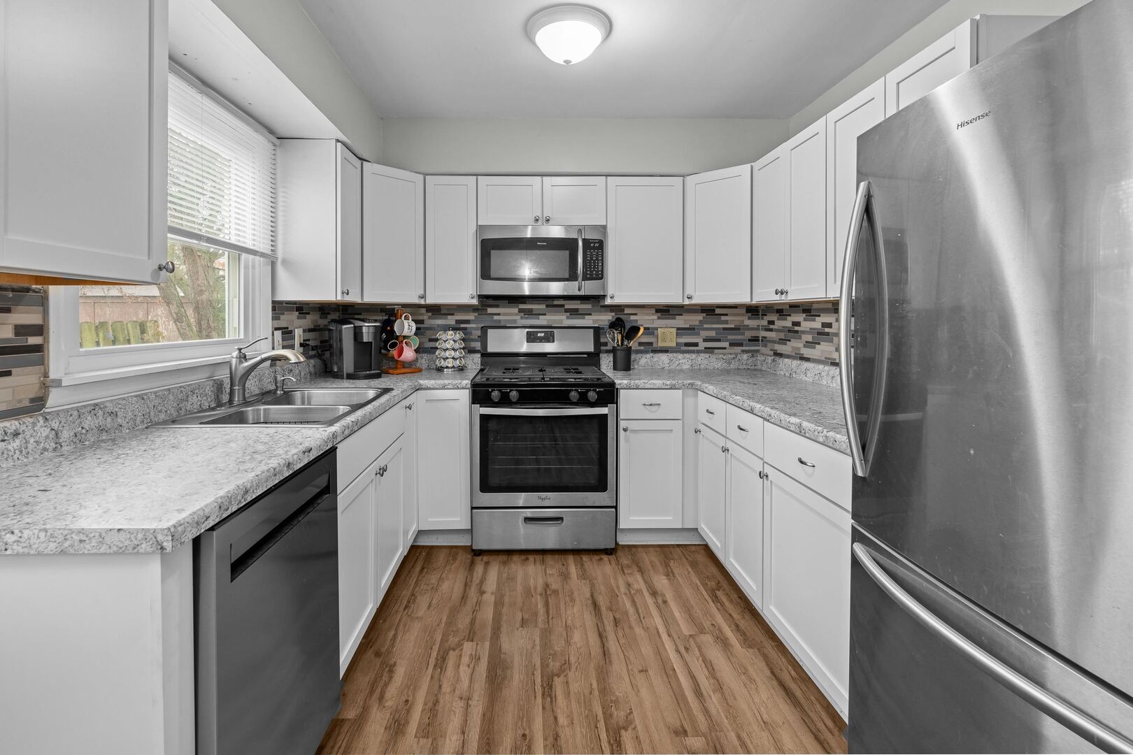 4315 26th Avenue Moline, IL 61265 - Photo 8 of 16 a kitchen with white cabinets stainless steel appliances and sink