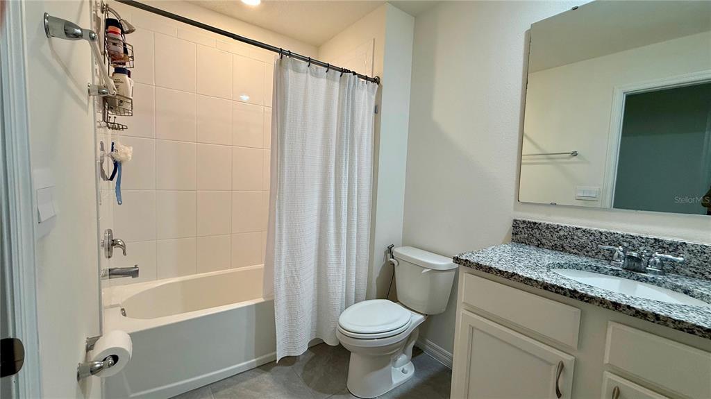 13340 Pontoon Road Winter Garden, FL 34787 - Photo 11 of 15 a bathroom with a granite countertop sink toilet and shower