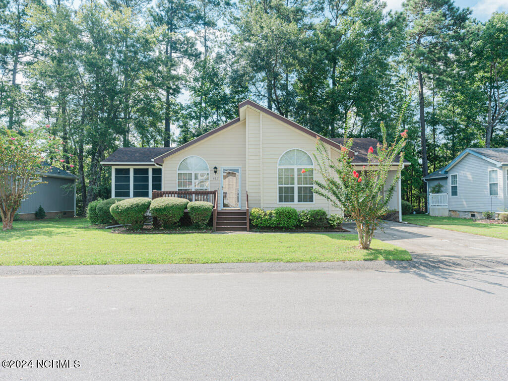 417 Deer Path Calabash, NC 28467 - Photo 23 of 32 This home has a concrete driveway and a carport with a dedicated storage room. The carport will keep the sun from beating up the paint job on your car all day.