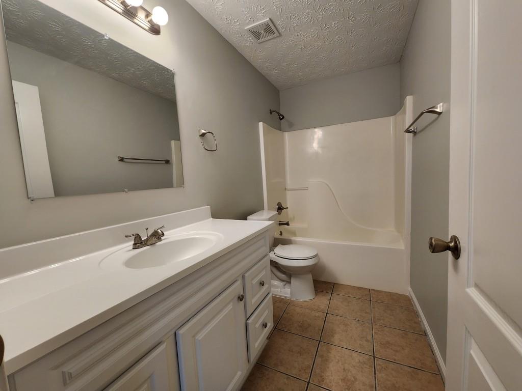 504 Dove Way Social Circle, GA 30025 - Photo 15 of 16 a bathroom with a sink a toilet and shower