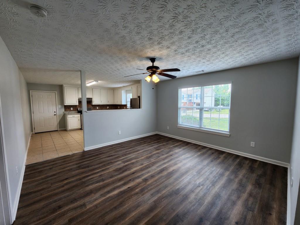 504 Dove Way Social Circle, GA 30025 - Photo 4 of 16 wooden floor in an empty room with a window