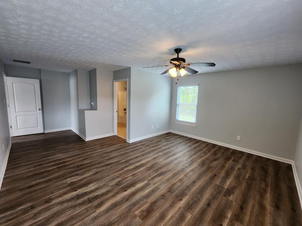 504 Dove Way Social Circle, GA 30025 - Photo 8 of 16 a view of an empty room with window and wooden floor