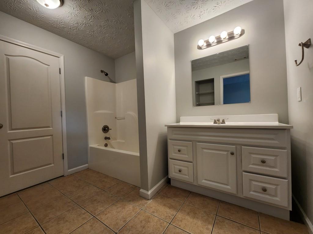 504 Dove Way Social Circle, GA 30025 - Photo 9 of 16 a bathroom with a sink and a mirror