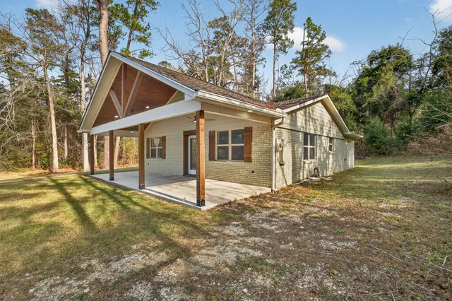 a view of a porch with wooden floor and fence