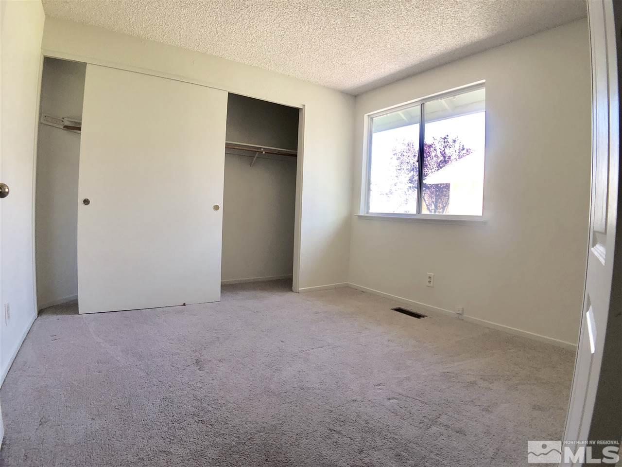 6364 Chesterfield Lane Reno, NV 89523 - Photo 17 of 29 an empty room with windows and closet
