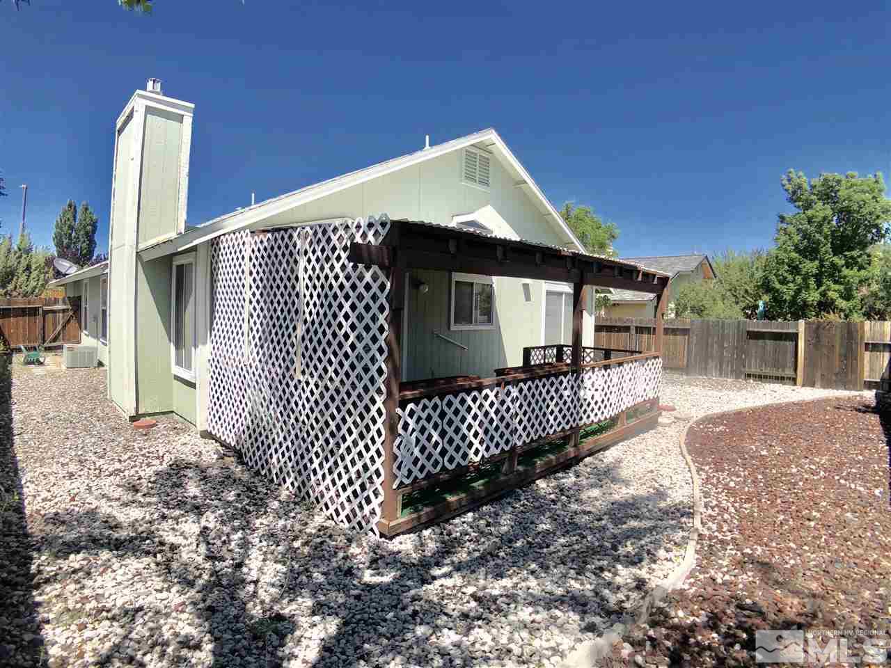 6364 Chesterfield Lane Reno, NV 89523 - Photo 26 of 29 a front view of a house with wooden fence
