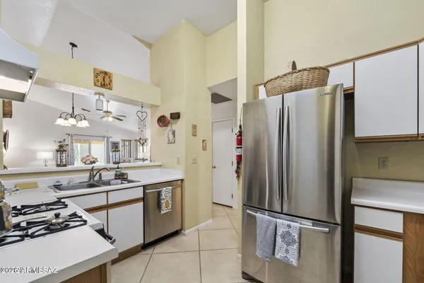 a kitchen with a stove top oven sink and cabinets