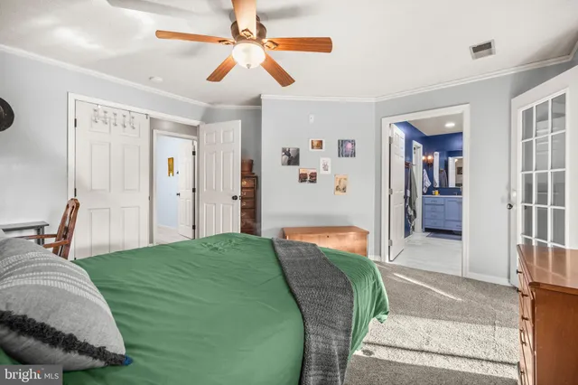 a bedroom with a large bed and a chandelier