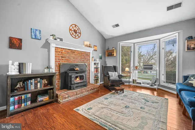 a view of a livingroom with furniture window and a fireplace