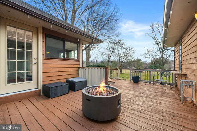 a view of a roof deck with wooden floor and fence
