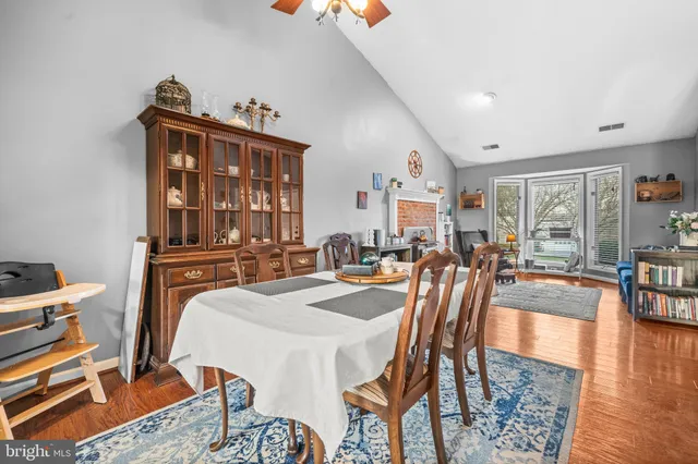 a dining room with furniture and wooden floor