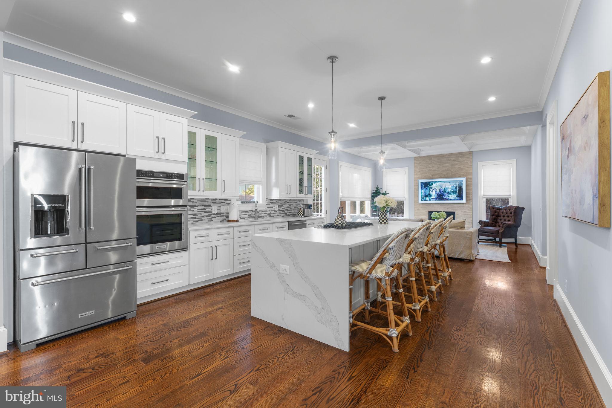 106 Tapawingo Road Southwest Vienna, VA 22180 - Photo 16 of 91 a kitchen with stainless steel appliances granite countertop a refrigerator a stove oven a sink dishwasher and white cabinets with wooden floor