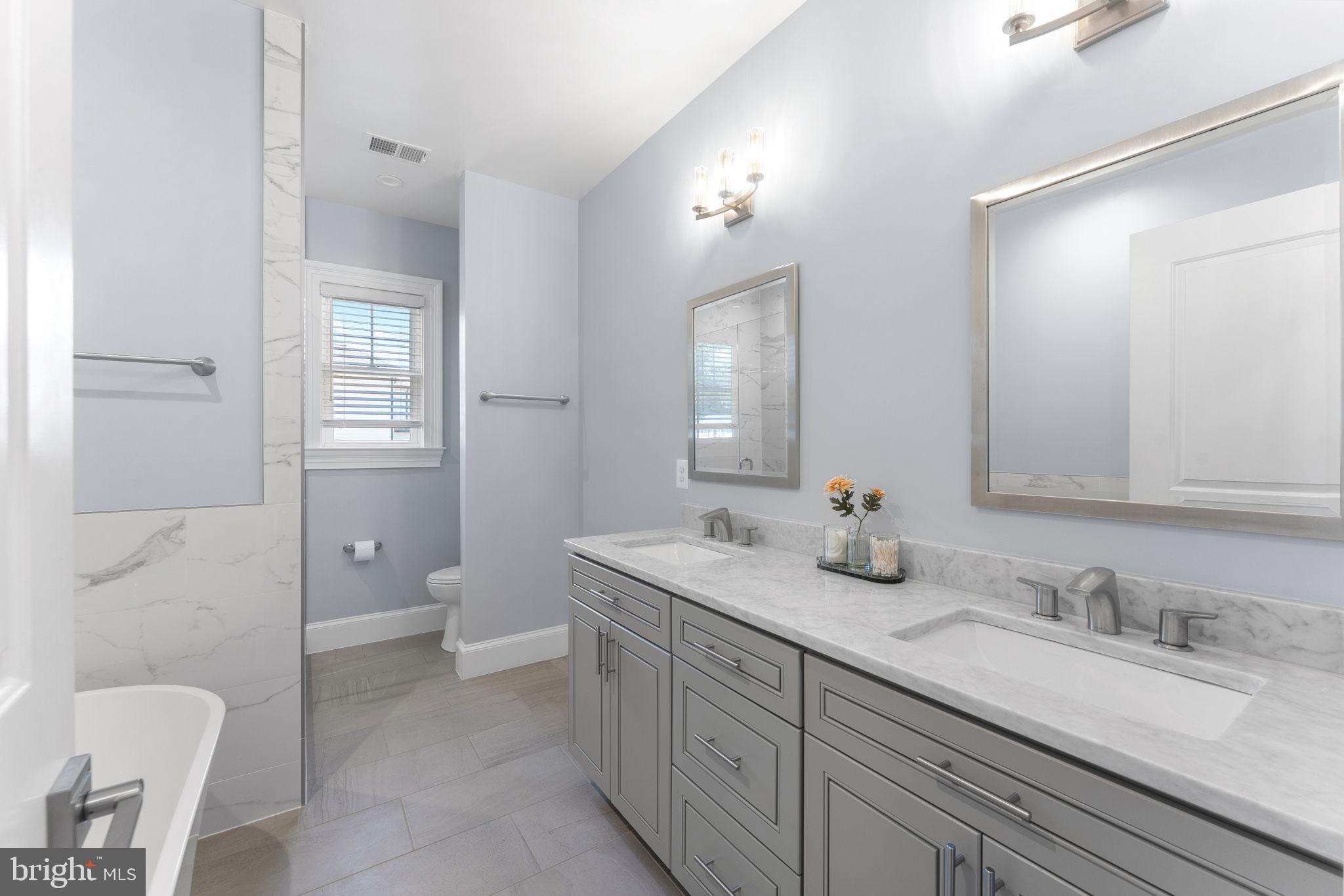 106 Tapawingo Road Southwest Vienna, VA 22180 - Photo 43 of 91 a bathroom with a granite countertop sink mirror and toilet