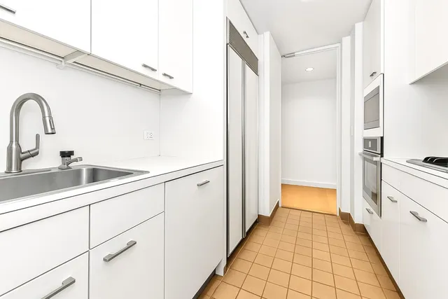 a kitchen with a sink and refrigerator