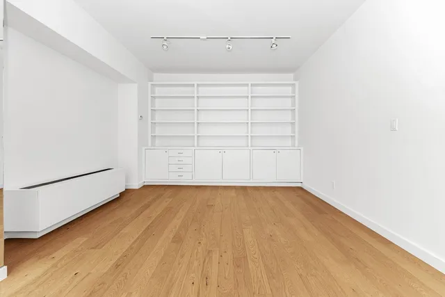 a view of a room with wooden floor