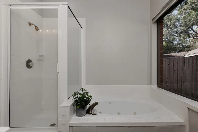 a bathroom with a bathtub and shower