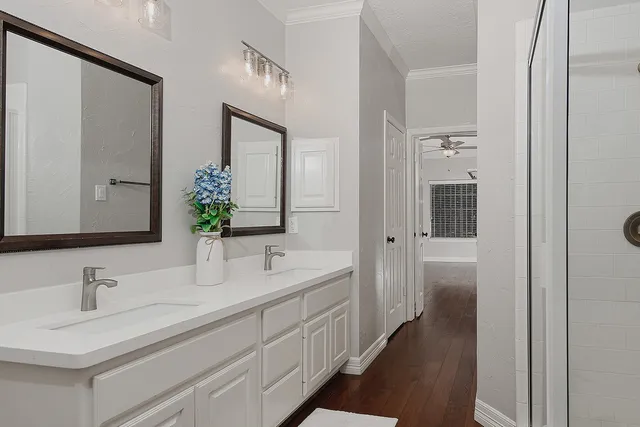 a bathroom with double vanity sinks and a mirror