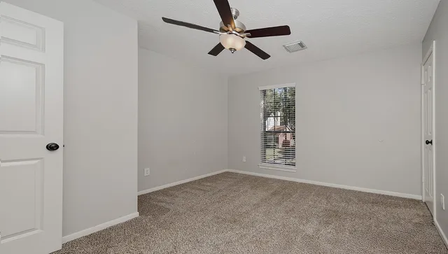 a view of an empty room and a window