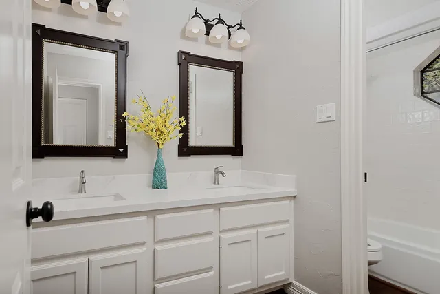 a bathroom with a sink vanity and mirror