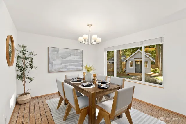 a dining room with furniture a potted plant and a chandelier