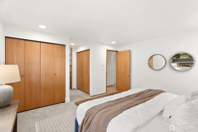 a bedroom with a large bed and a closet