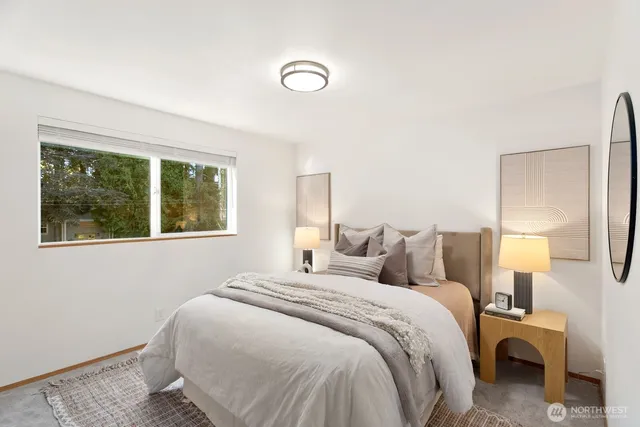 a bedroom with a bed and a large window