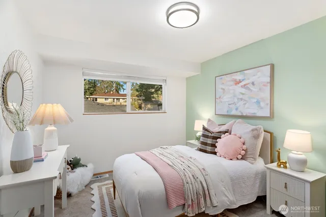 a bedroom with a bed and a painting on the wall